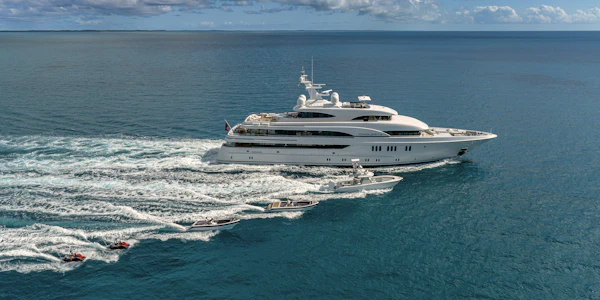 Marguerite Yacht sailing on the ocean with smaller boats next to it